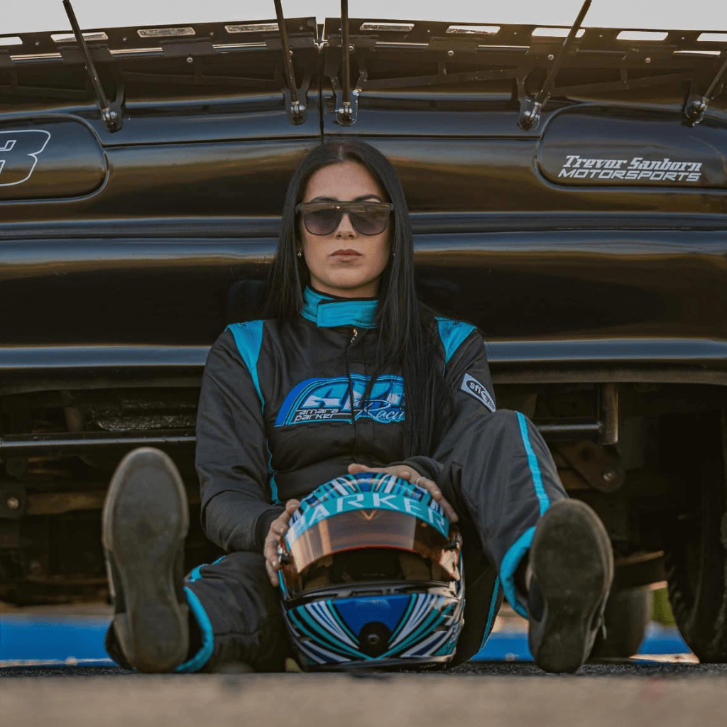 Female racer in custom racing suit with helmet