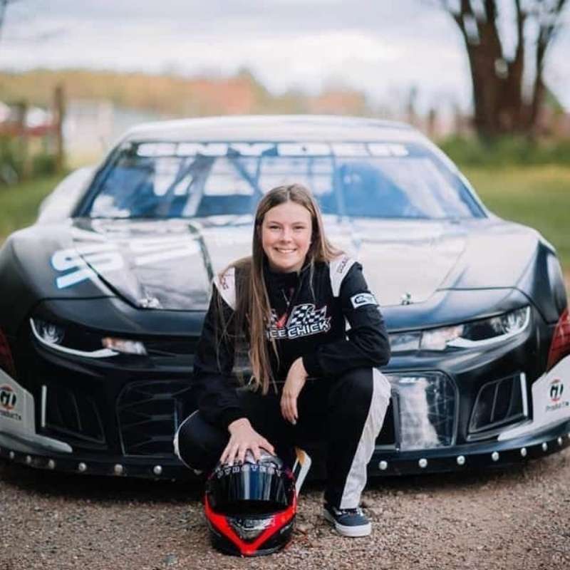 Race car driver with helmet in front of race car design