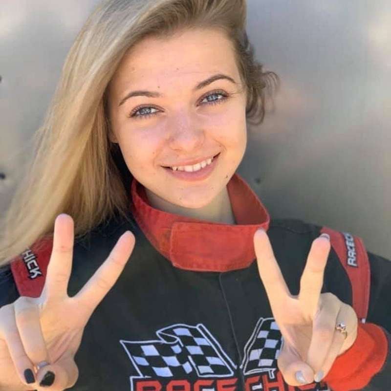 Race car driver with victory sign
